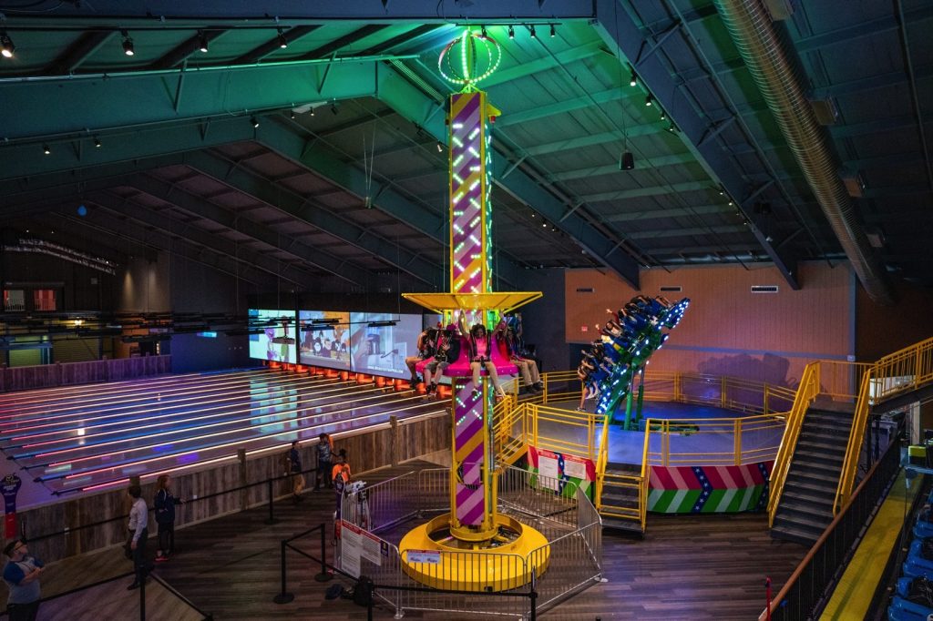 people twirling around on an indoor ride at The Funplex East Hanover