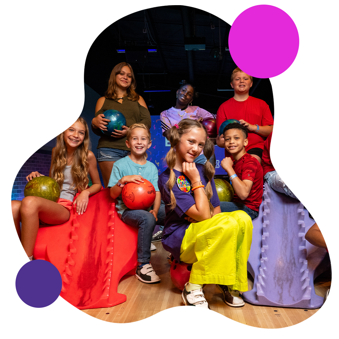 Image of kids smiling at a bowling alley