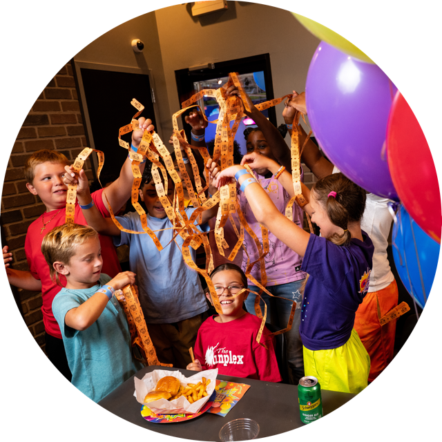 Image of a group of kids at a Funplex Party celebrating with arcade tickets